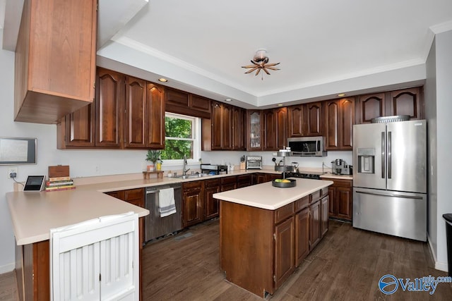 9046 Sugar Tree Trl, Huntsville, AL 35802 - kitchen featuring stainless steel appliances, light countertops, dark wood-type flooring, ornamental molding, and a center island