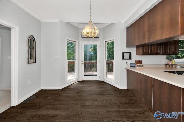 9046 Sugar Tree Trl, Huntsville, AL 35802 - kitchen featuring light countertops, a chandelier, dark wood-type flooring, pendant lighting, and dark brown cabinets
