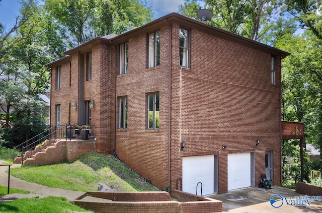 9046 Sugar Tree Trl, Huntsville, AL 35802 - view of building exterior featuring an attached garage and concrete driveway