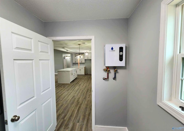 hall featuring dark wood-type flooring and a textured ceiling