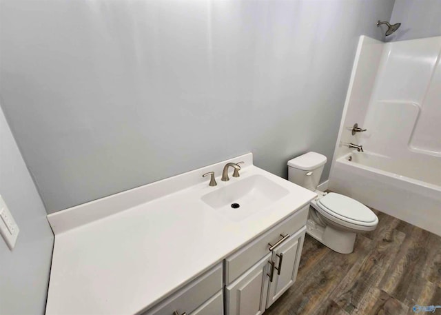 full bathroom featuring vanity, wood-type flooring, shower / bathtub combination, and toilet