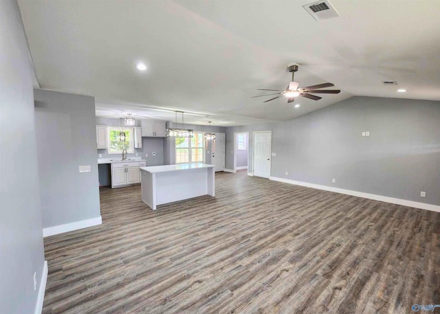 kitchen featuring pendant lighting, white cabinetry, sink, hardwood / wood-style flooring, and ceiling fan