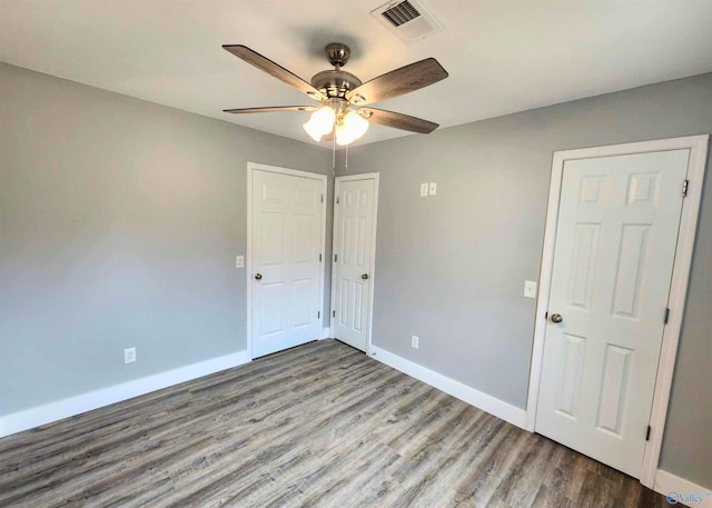 unfurnished room with ceiling fan and wood-type flooring