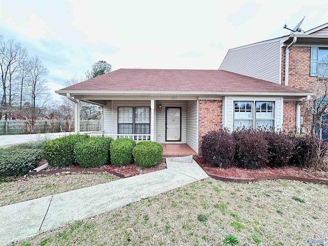 view of front of home featuring a porch and brick siding