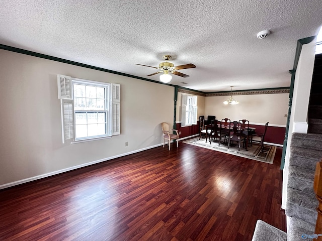 dining area with ceiling fan with notable chandelier, ornamental molding, wood finished floors, and baseboards