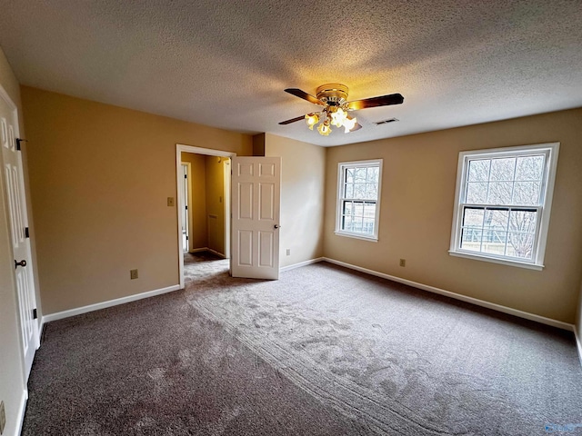 unfurnished bedroom with a ceiling fan, baseboards, visible vents, and carpet flooring