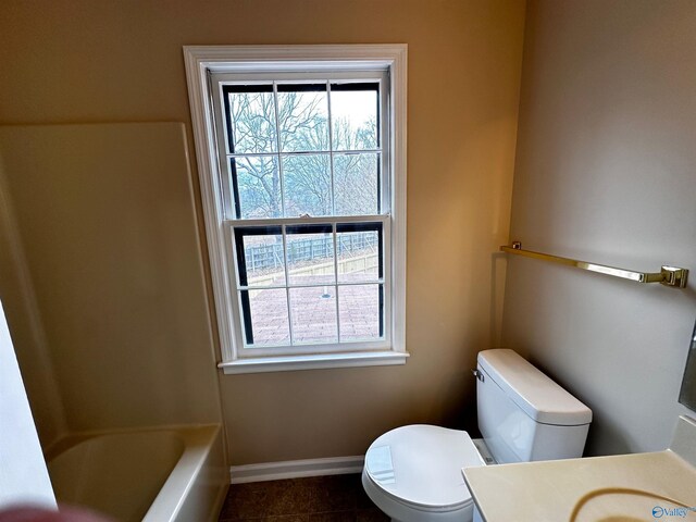 full bathroom with toilet, baseboards, a wealth of natural light, and vanity