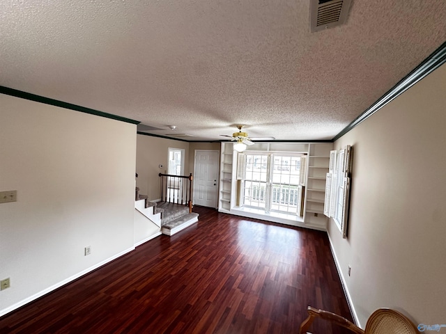 unfurnished living room with visible vents, stairway, wood finished floors, crown molding, and a textured ceiling