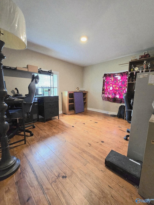 office space featuring baseboards and wood finished floors