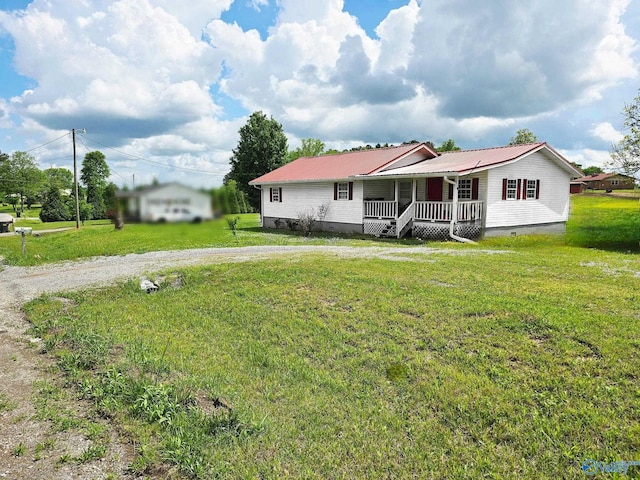 view of front of property with a porch, crawl space, driveway, metal roof, and a front lawn