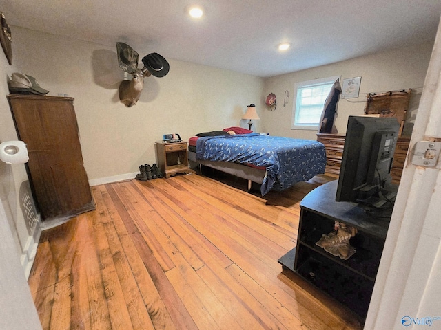 bedroom with recessed lighting, baseboards, and hardwood / wood-style floors