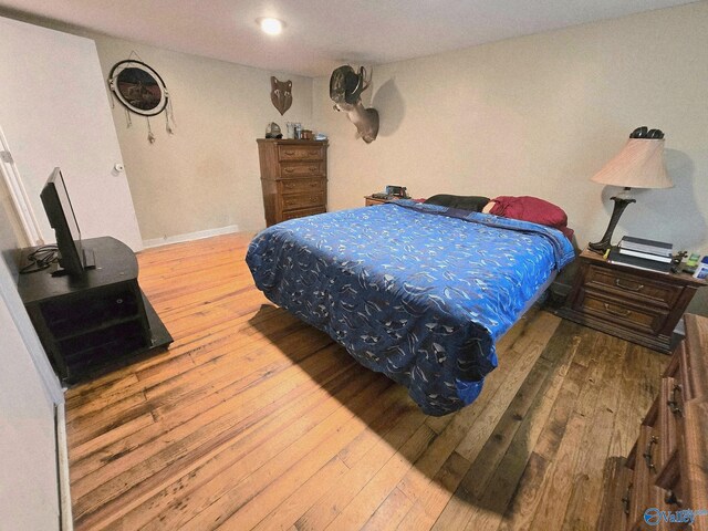 bedroom with hardwood / wood-style floors