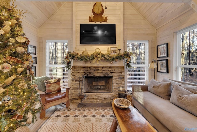 living room with a wealth of natural light, wooden ceiling, and wood walls