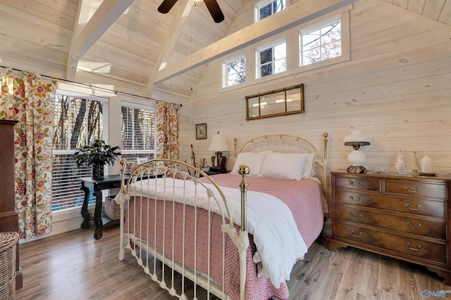 bedroom featuring beamed ceiling, ceiling fan, wood-type flooring, and wooden ceiling