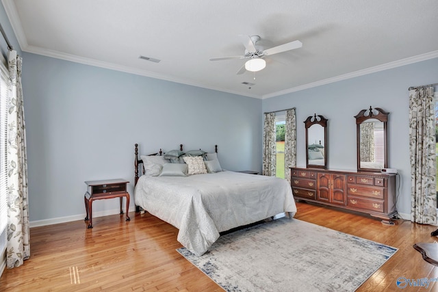 bedroom featuring ceiling fan, light hardwood / wood-style floors, and crown molding