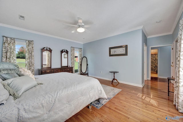 bedroom featuring light hardwood / wood-style flooring, ceiling fan, and crown molding