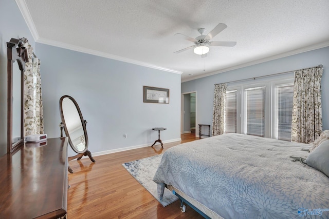 bedroom with ceiling fan, ornamental molding, a textured ceiling, and light hardwood / wood-style flooring