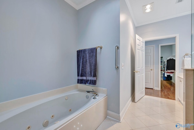 bathroom featuring a tub, crown molding, tile patterned flooring, and vanity