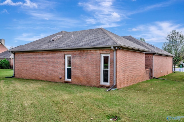 rear view of house with a lawn