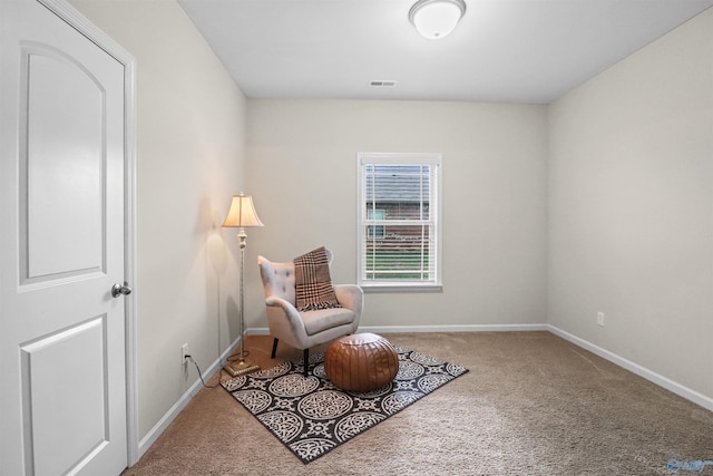 sitting room featuring baseboards, visible vents, and carpet floors