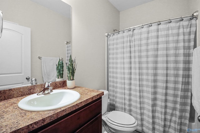 bathroom with toilet, vanity, and a shower with shower curtain