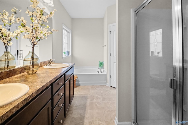 bathroom with a stall shower, a bath, and a sink