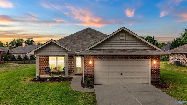 traditional home with a lawn, brick siding, driveway, and an attached garage