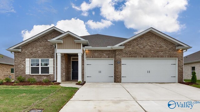 view of front of home with a garage and a front lawn