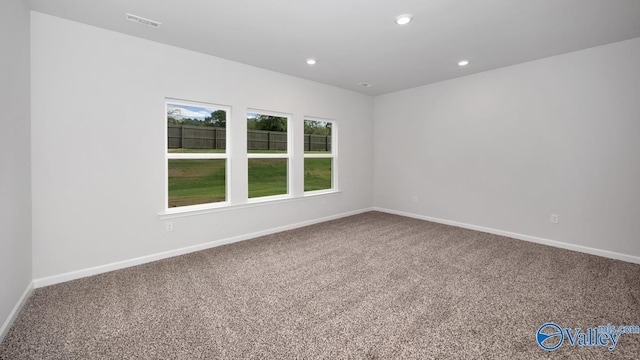 carpeted spare room with recessed lighting, visible vents, and baseboards