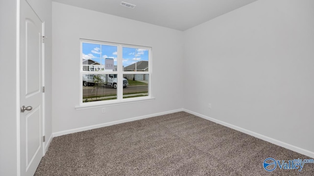 carpeted empty room with visible vents and baseboards