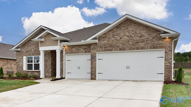 view of front of home featuring brick siding, an attached garage, and driveway