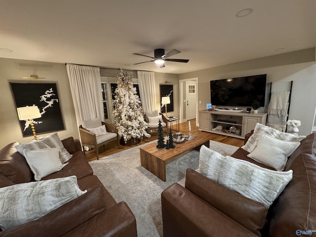 living room featuring hardwood / wood-style floors and ceiling fan