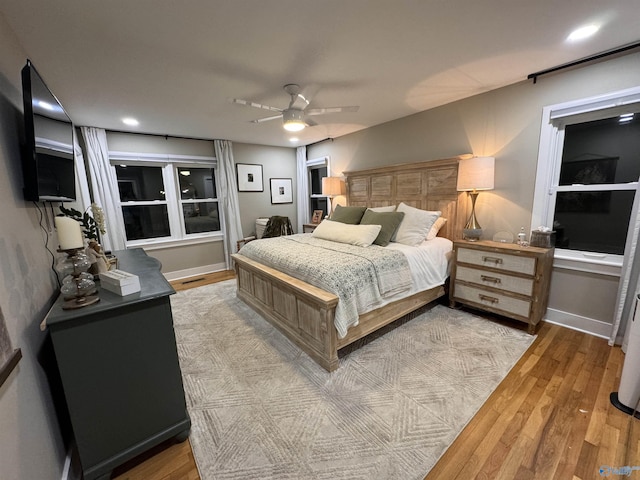 bedroom featuring light hardwood / wood-style flooring and ceiling fan