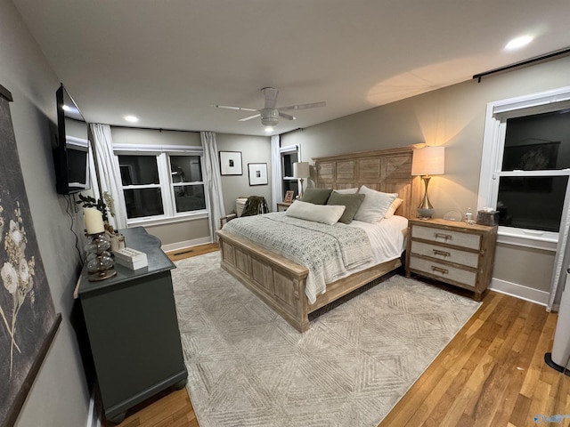 bedroom featuring ceiling fan and light hardwood / wood-style flooring