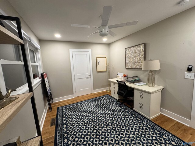 home office with ceiling fan and light wood-type flooring