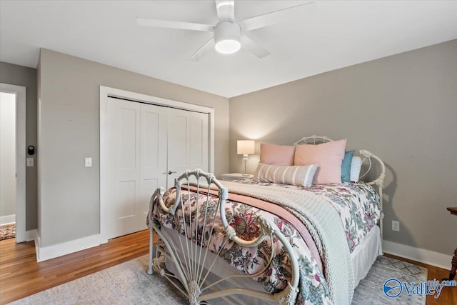 bedroom featuring ceiling fan, a closet, and wood-type flooring