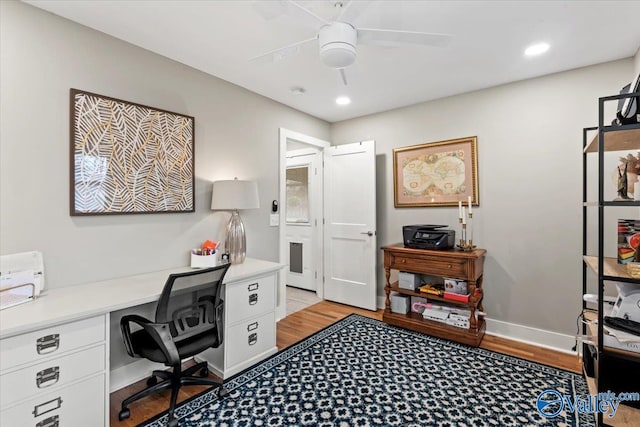 home office with light hardwood / wood-style floors and ceiling fan