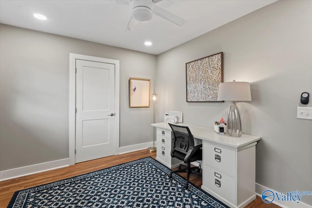 home office with dark hardwood / wood-style floors and ceiling fan