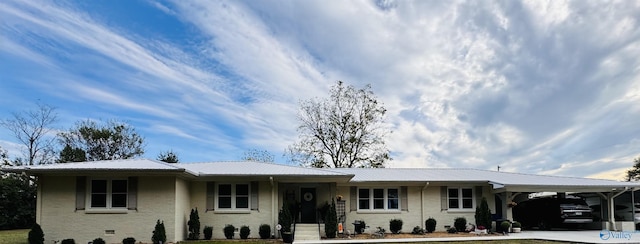 ranch-style home featuring a front yard and a carport