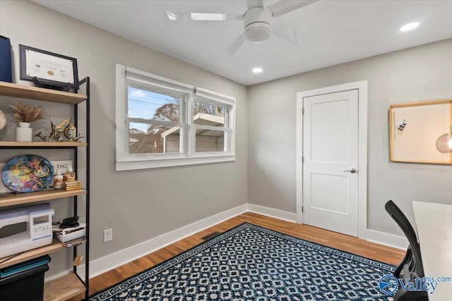 home office with ceiling fan and light hardwood / wood-style flooring