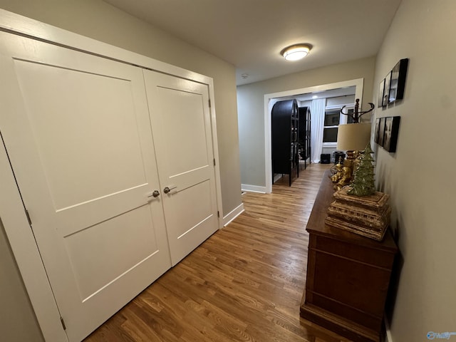 corridor with hardwood / wood-style floors