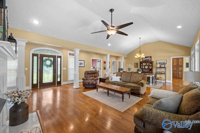 219 Sharp Dr, Gadsden, AL 35903 - living room featuring decorative columns, lofted ceiling, a ceiling fan, wood finished floors, and a chandelier