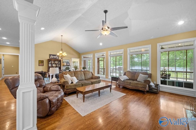 219 Sharp Dr, Gadsden, AL 35903 - living room featuring decorative columns, wood finished floors, ceiling fan, lofted ceiling, and a textured ceiling