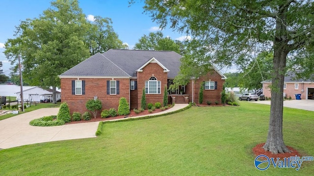 219 Sharp Dr, Gadsden, AL 35903 - view of front of house featuring a front yard, brick siding, and driveway
