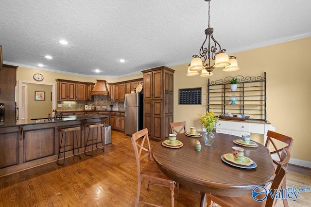 219 Sharp Dr, Gadsden, AL 35903 - dining area with ornamental molding, a chandelier, light wood-type flooring, recessed lighting, and a textured ceiling