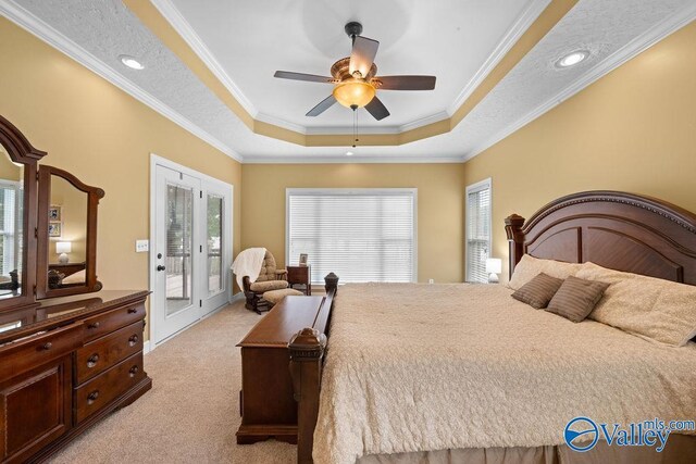 219 Sharp Dr, Gadsden, AL 35903 - bedroom featuring light carpet, access to exterior, a raised ceiling, crown molding, and multiple windows