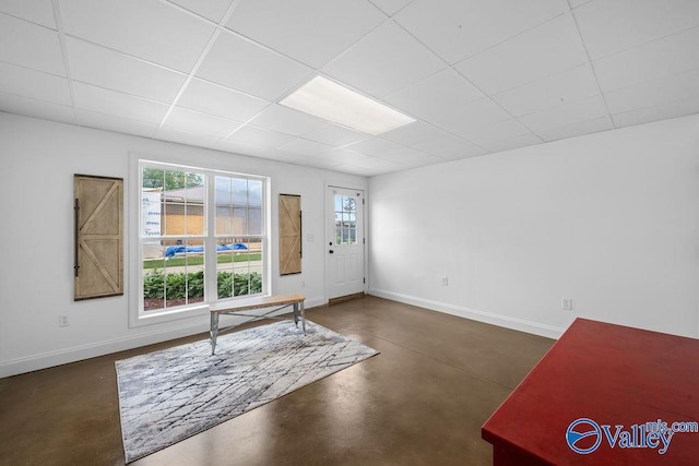 219 Sharp Dr, Gadsden, AL 35903 - entrance foyer with finished concrete flooring, baseboards, a paneled ceiling, and plenty of natural light