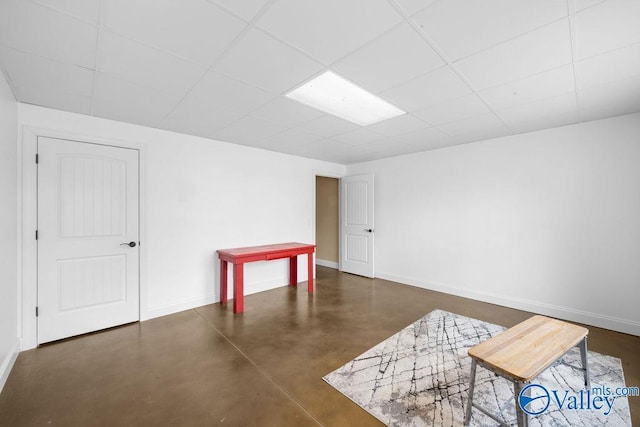 219 Sharp Dr, Gadsden, AL 35903 - empty room with concrete flooring, baseboards, and a drop ceiling