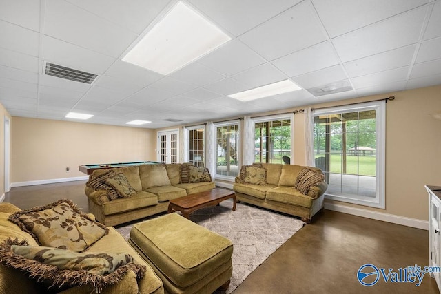219 Sharp Dr, Gadsden, AL 35903 - living room featuring baseboards, concrete flooring, billiards, and a drop ceiling