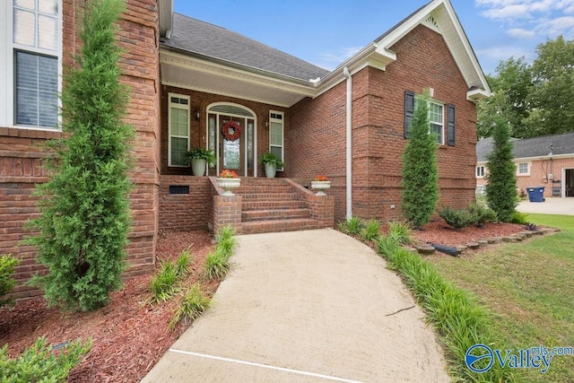 219 Sharp Dr, Gadsden, AL 35903 - doorway to property with brick siding, roof with shingles, and covered porch